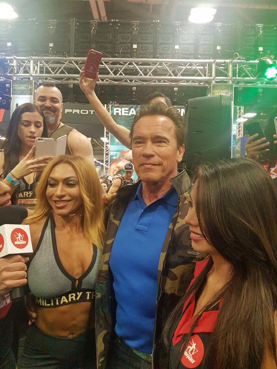 Karina Nascimento & Midway Labs VP Catherine Colle posing for a picture with Arnold.